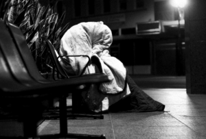 Rough sleeper sitting on a bench