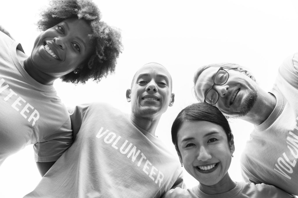 People wearing t-shirts woth the word volunteer