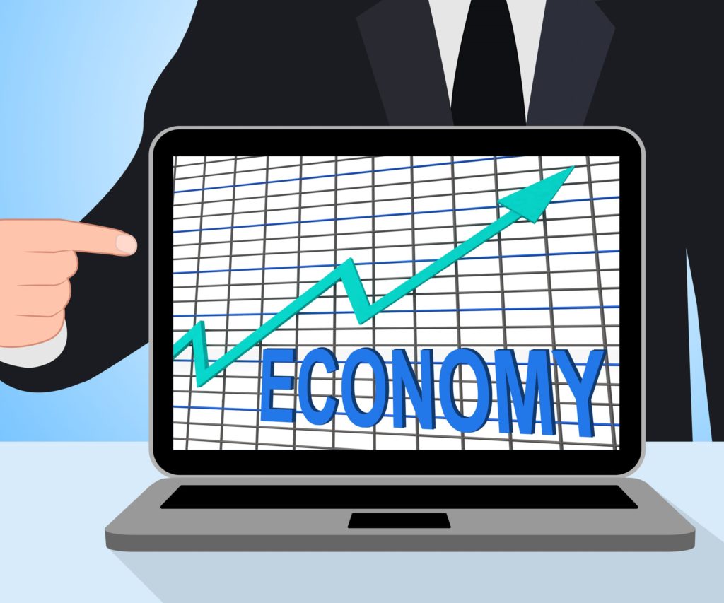 Businessman pointing to Economic Growth graph on laptop computer screen