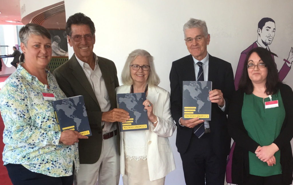 The GIMMS Team with Warren Mosler and Bill Mitchell holding copies of the book Macroeconomics