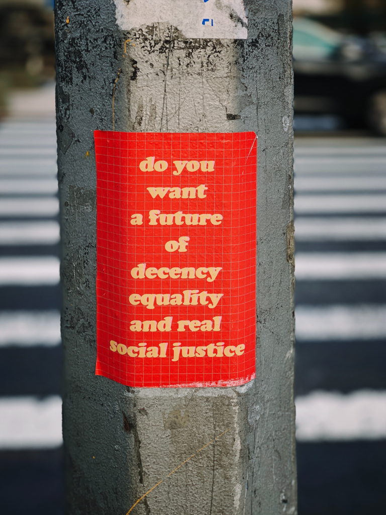 Poster on lamppost with the slogan do you want a future of decency equality and real social justice