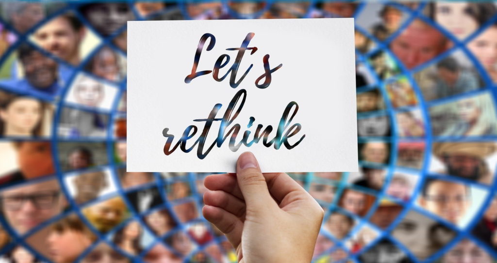 Hand holding note with the slogan "let's rethink"
