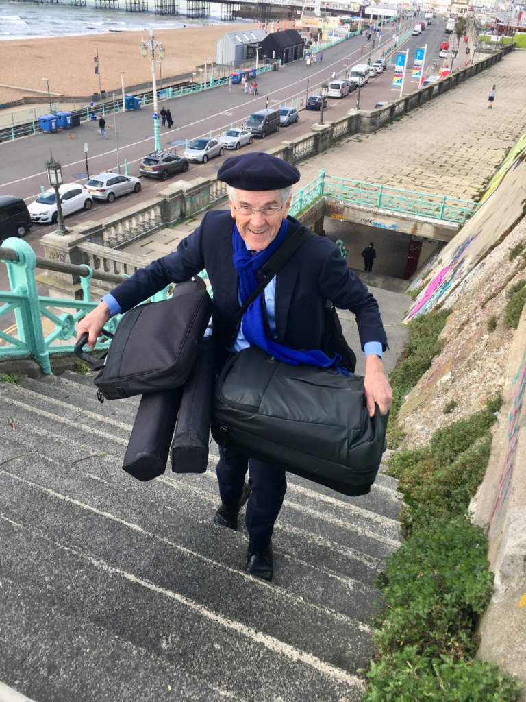 Professor Bill Mitchell carrying someof the GIMMS team's equipment up the steps at Brighton seafront