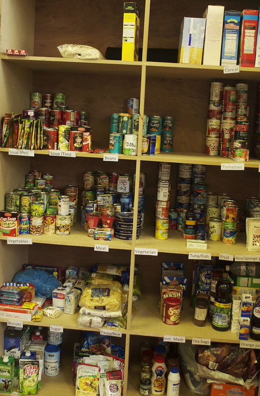 Food Bank Cupboard stocked with tinned and packet food