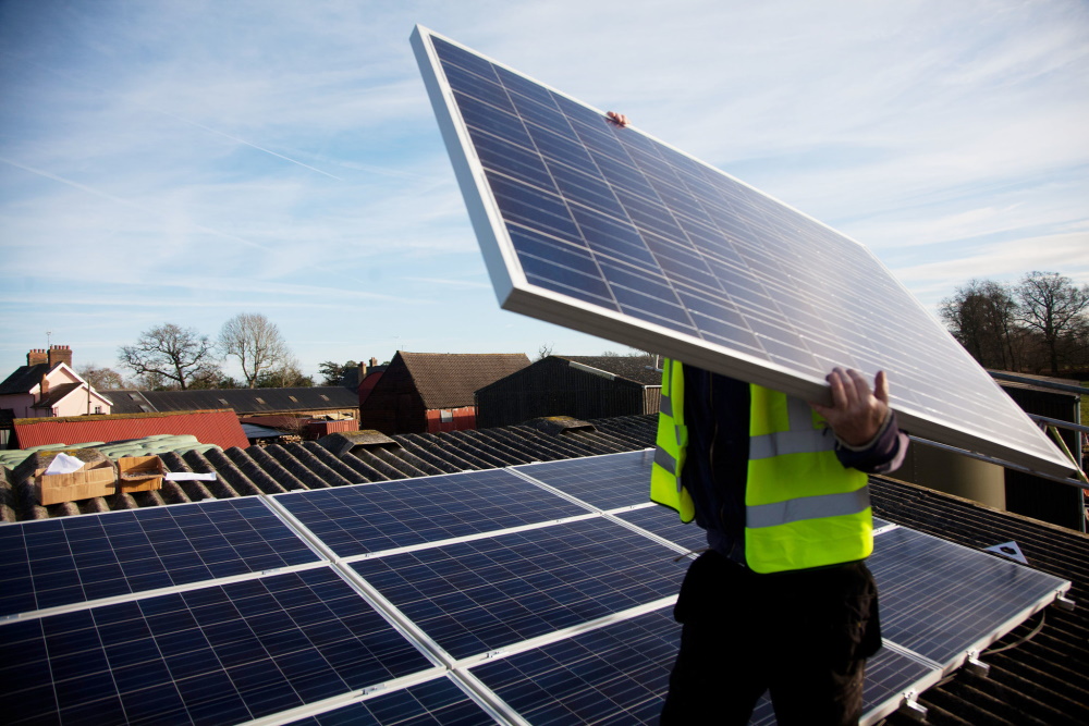 Worker installing solar panels