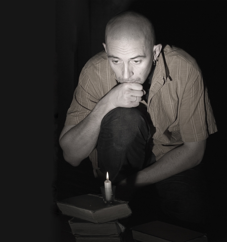 Man kneeling in candlelight