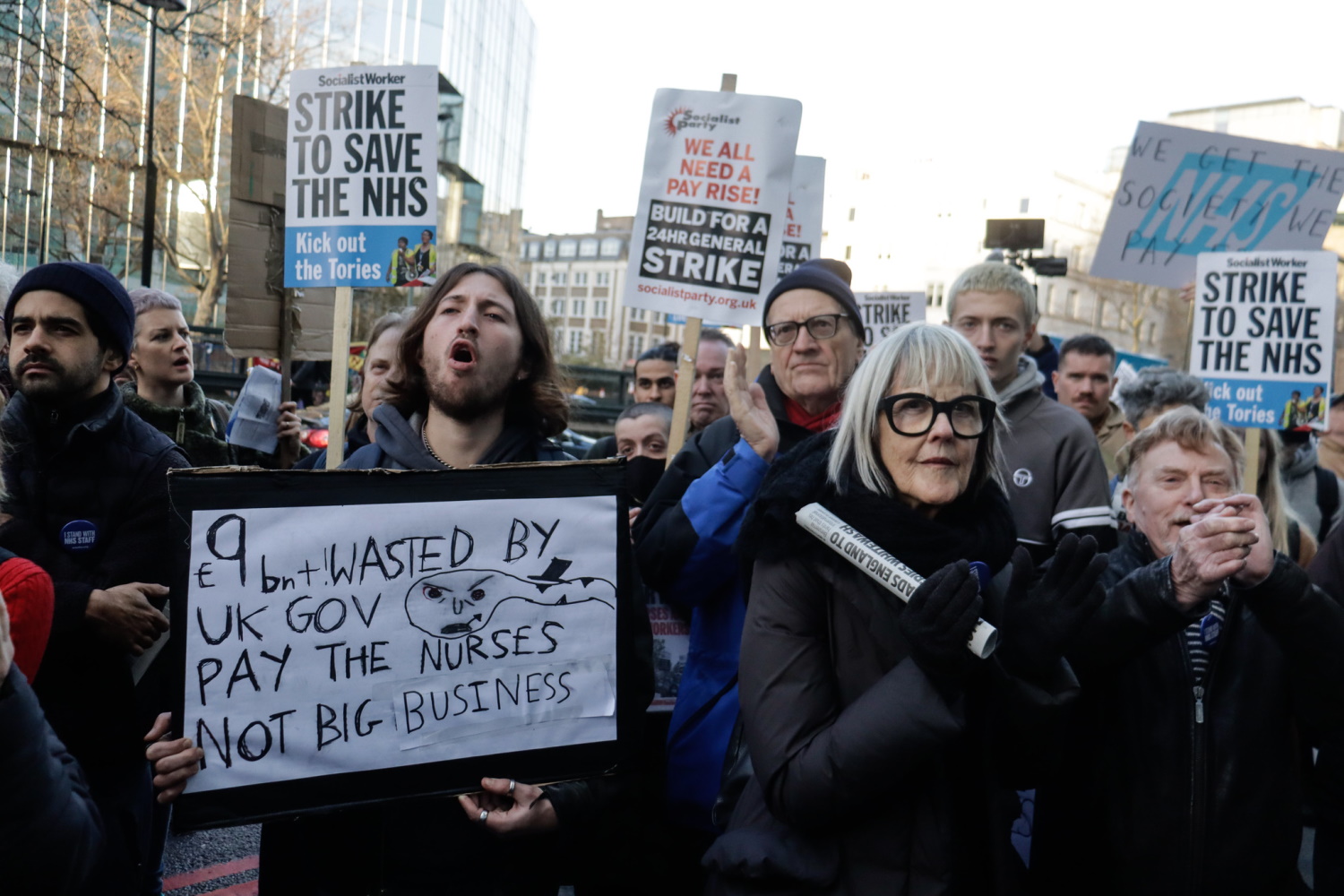 Protesters holding placards at a demonstration during the NHS nurses' strike.